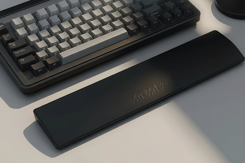 Black wrist rest pad with a computer keyboard on a desk, showing a close-up of hands typing.